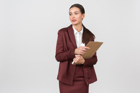 Attractive formally dressed woman holding a clipboard