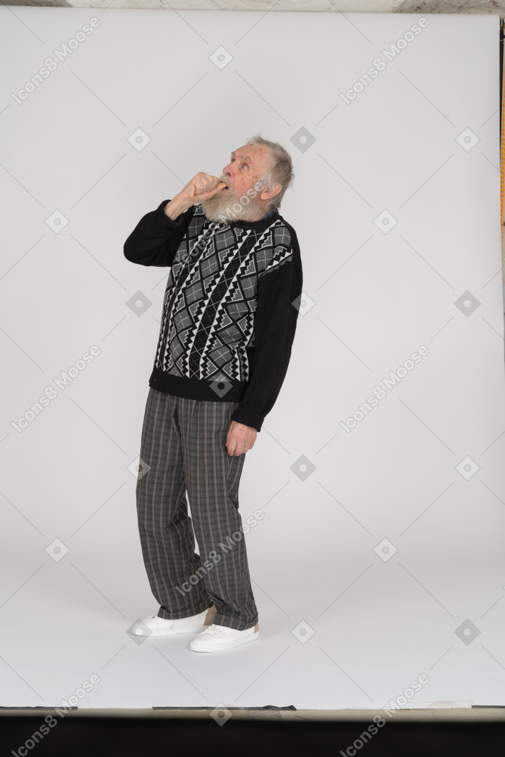 Surprised old man covering mouth with fist