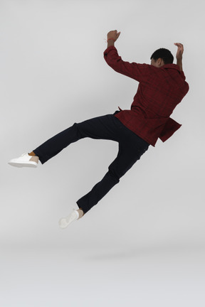 Back view of black man jumping