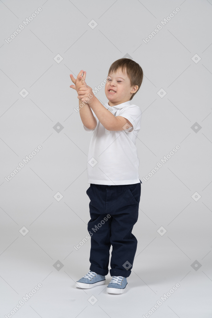 Little boy squeezing his own arm