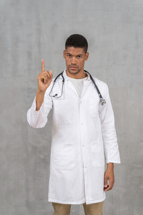 Disapproving male doctor shaking his finger