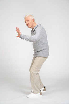 Side view man showing stop gesture with hand