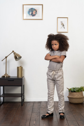 Good looking girl kid posing on the apartment background