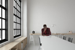 A frustrated man sitting at a table in an office