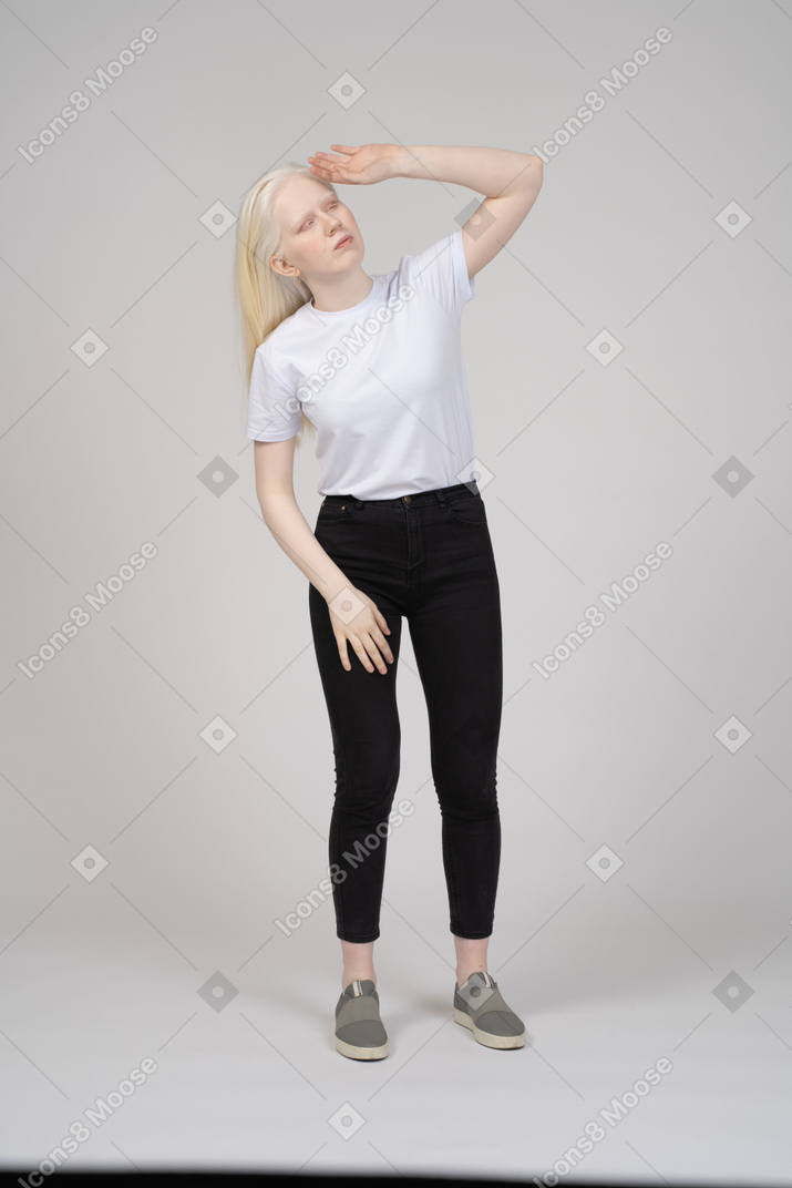 Girl standing and fixing hair