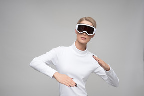 Young woman in ski goggles performing a modern dance