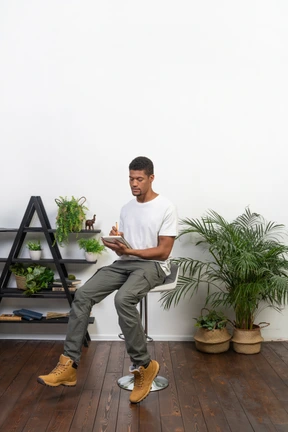 Good looking young man sitting on a chair