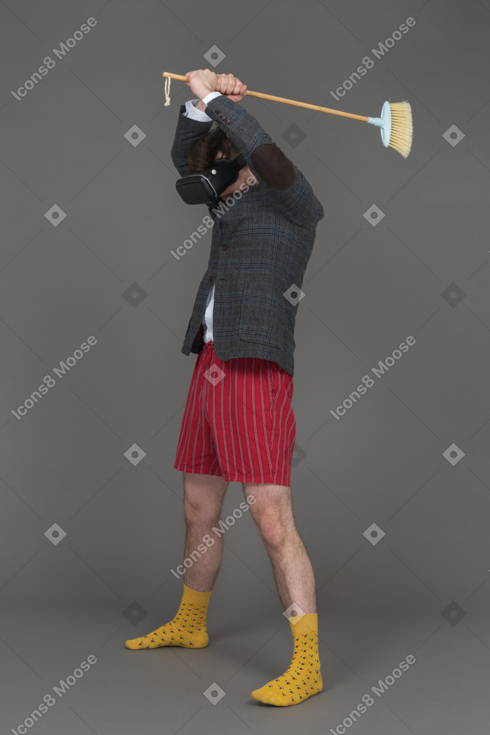 Man in vr headset with a broom