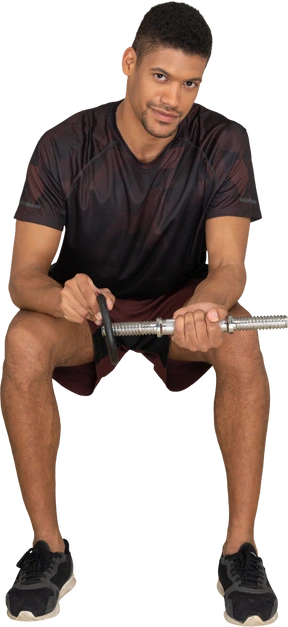 Young man in sports clothes sitting