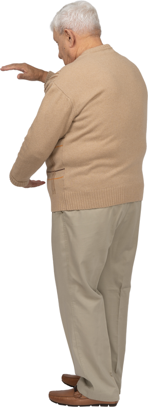 Seitenansicht eines alten mannes in freizeitkleidung, der die größe von etwas zeigt