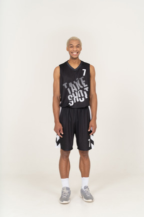 Front view of a smiling young male basketball player standing still