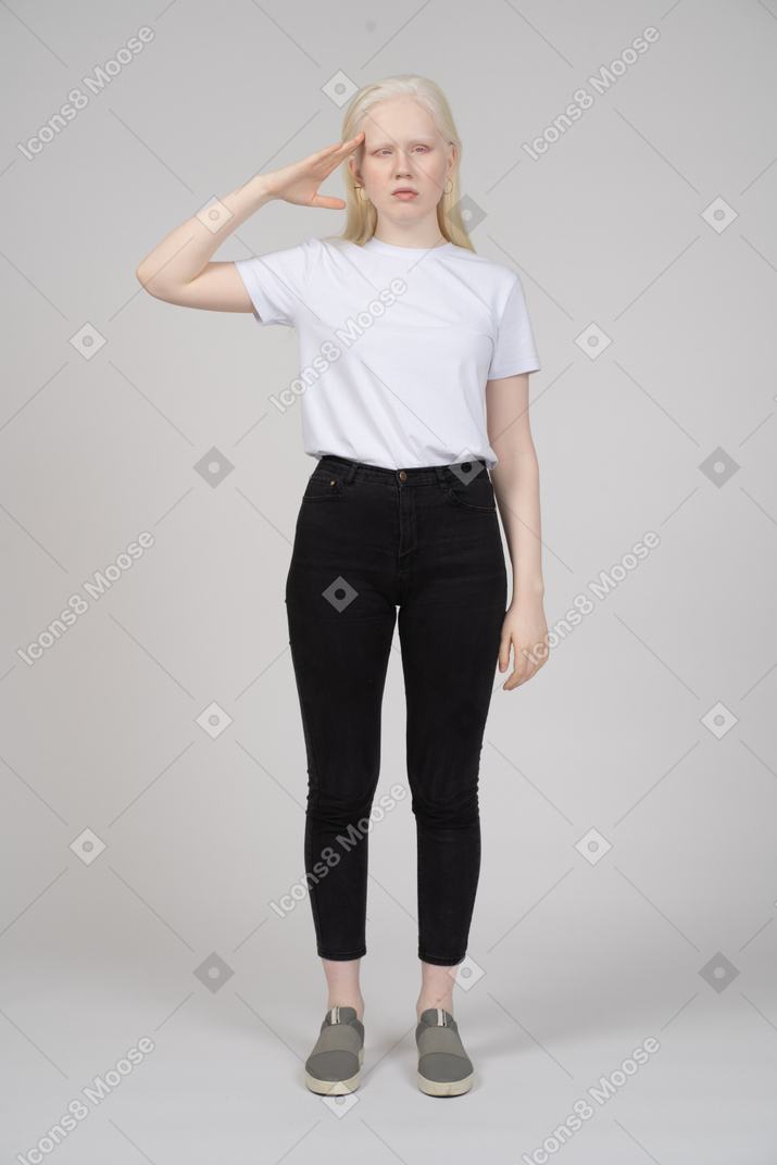 Young woman in casual clothes giving a salute