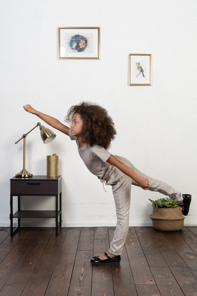 Good looking girl kid posing on the apartment background