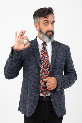 Mature man holding nem coin