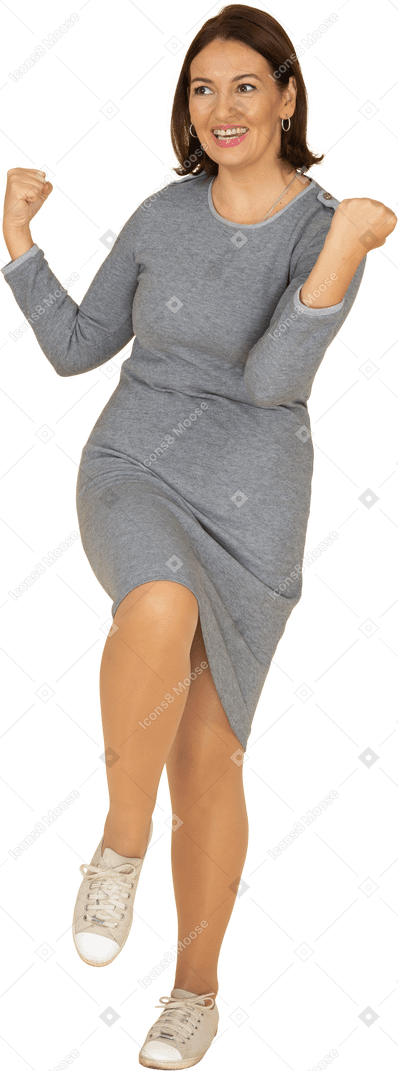 Front view of a happy woman in grey dress