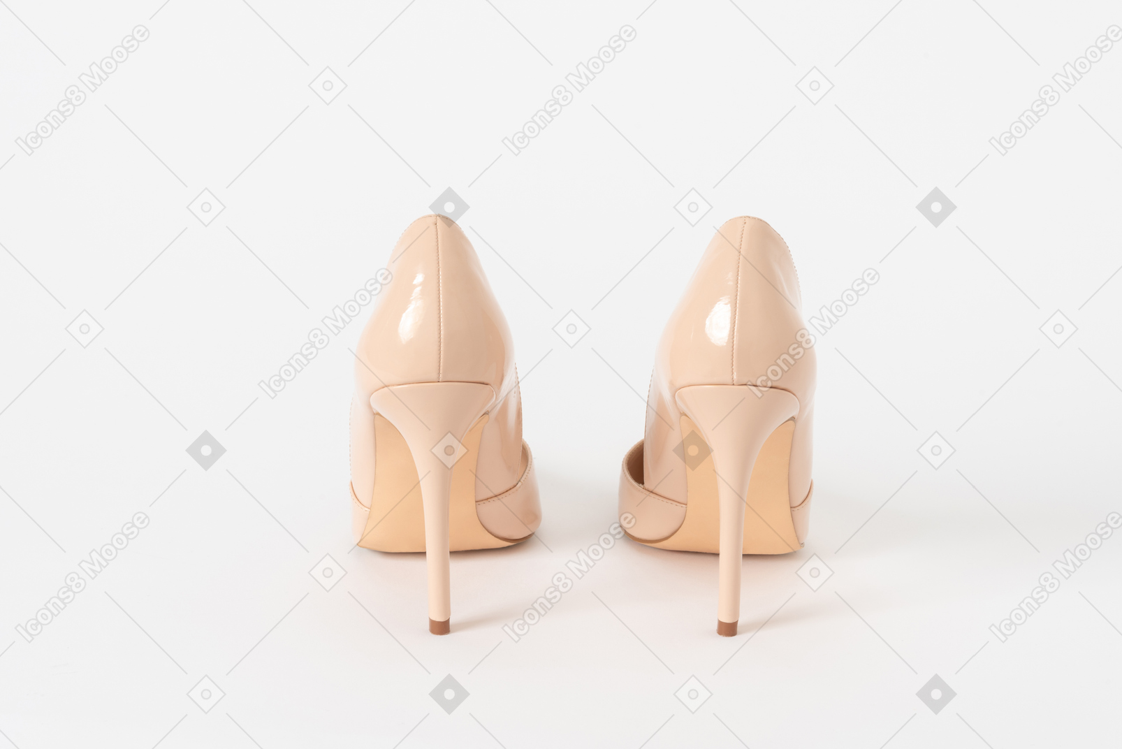 A back shot of a pair of beige lacquered stiletto shoes