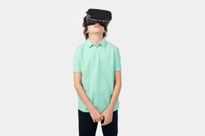 Boy in virtual reality headset looking up