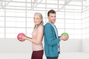 A man and a woman holding balls in their hands