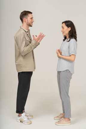 Side view of young couple speaking to each other