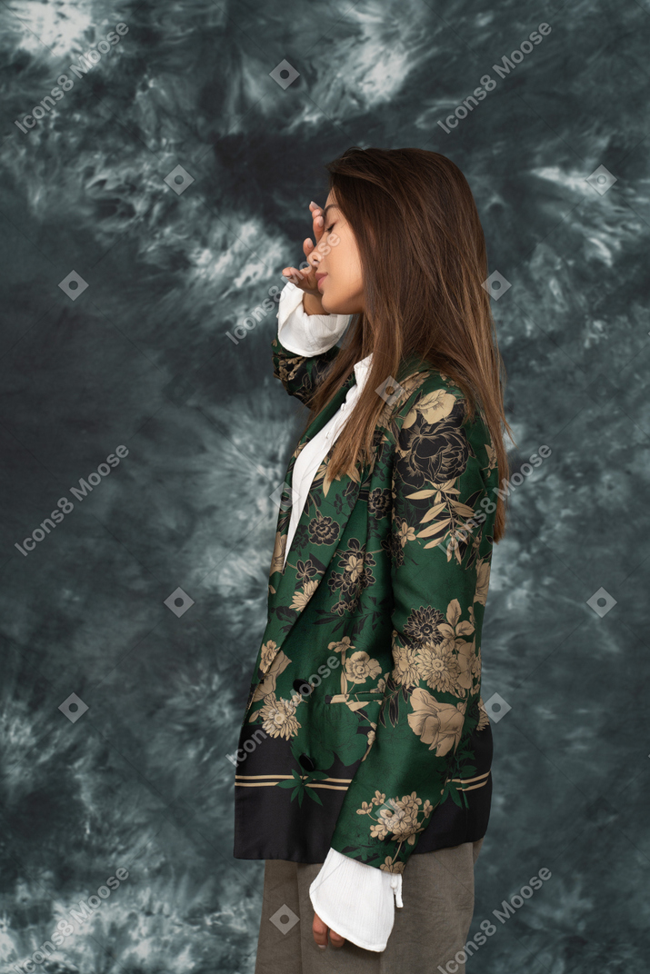 Side photo of female model having a headache