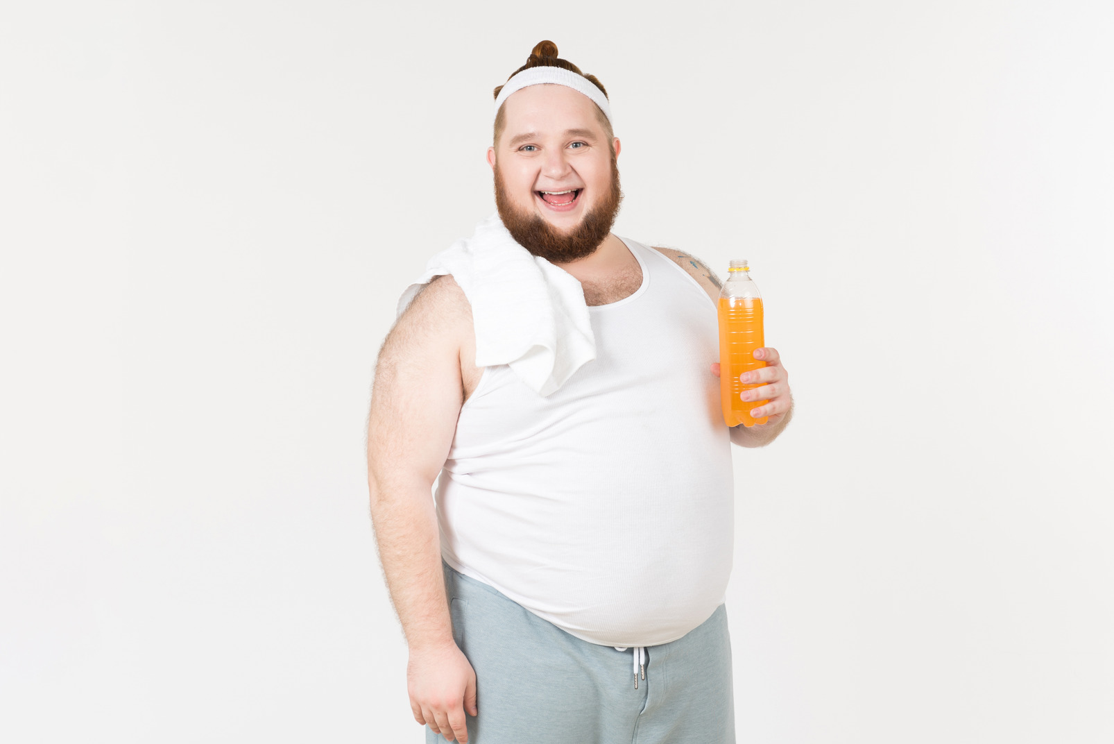 A fat man in sportswear holding a bottle of soft drink and smiling