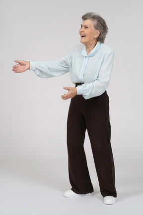 Three-quarter view of an old woman gesturing welcomingly