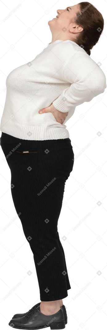 Plump woman in white sweater suffering from pain in lower back