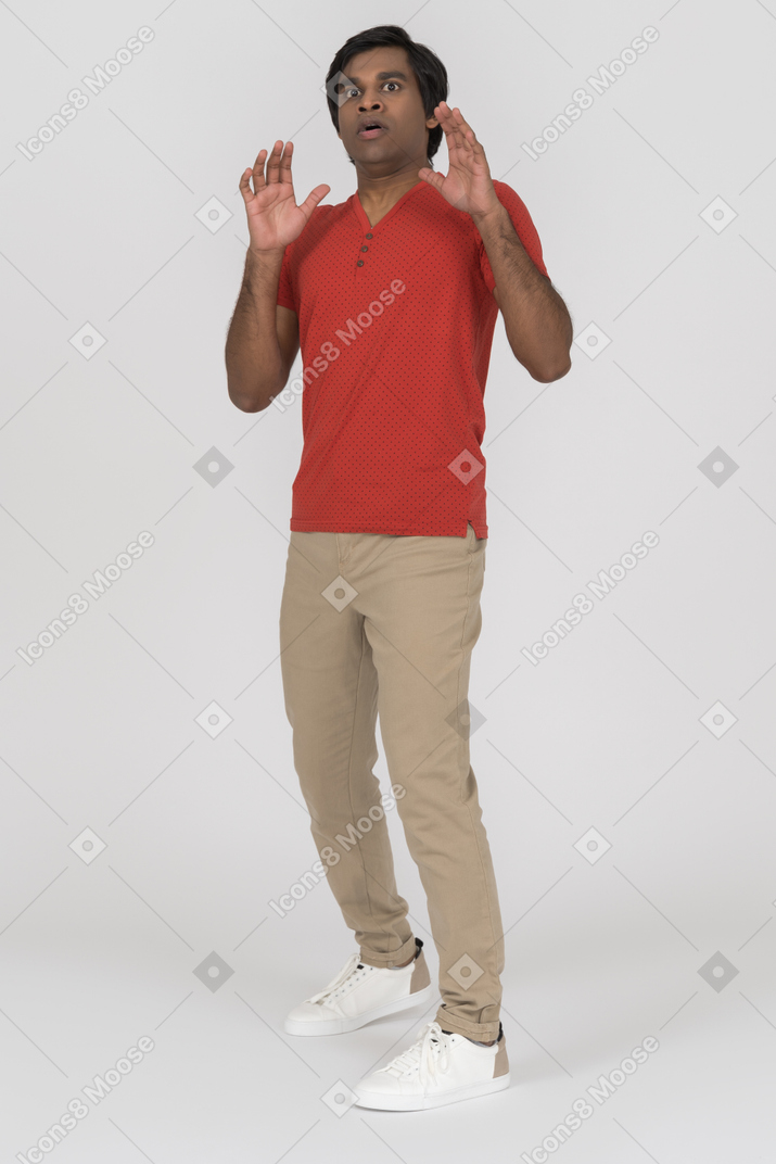 Young man leaning backwards with hands up