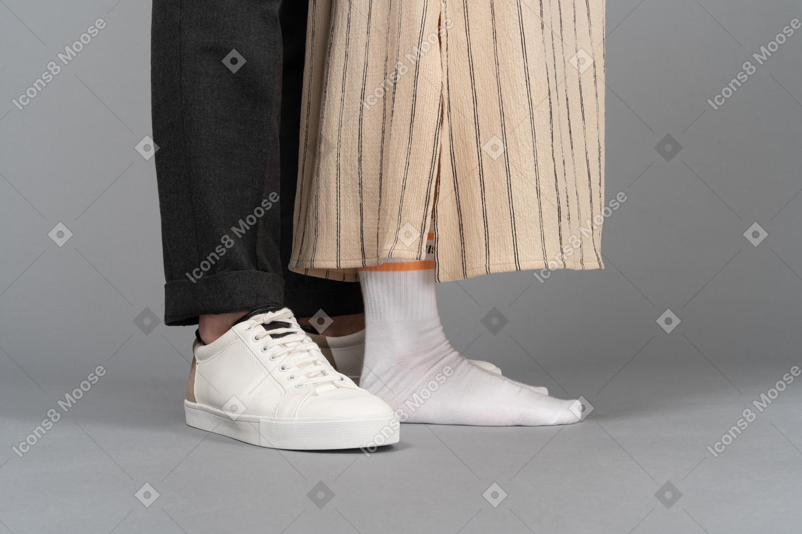 Close-up of man's sneakers and woman's socks