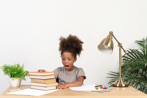 Good looking cute girl with books at the table