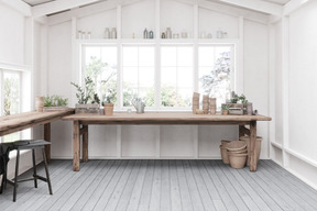 Interior with large windows and ceramic pots on a wooden table