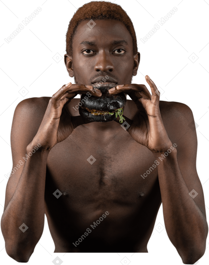 Vista frontal de um jovem afro segurando um hambúrguer