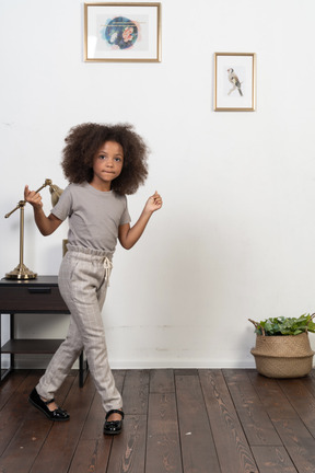 Good looking girl kid posing on the apartment background