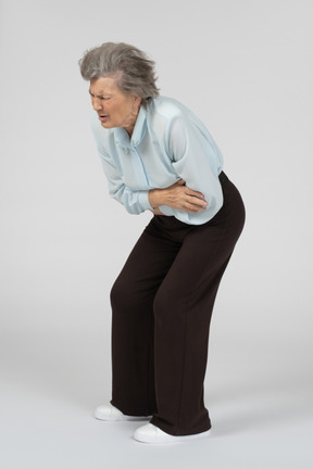 Old woman having stomach ache