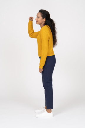 Side view of a girl in casual clothes showing a small size of something
