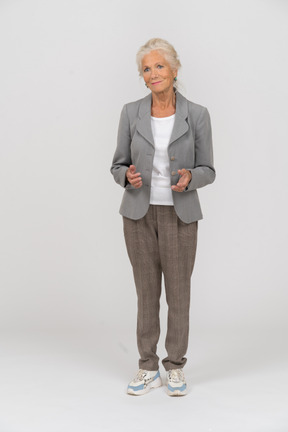 Front view of a happy old lady in suit
