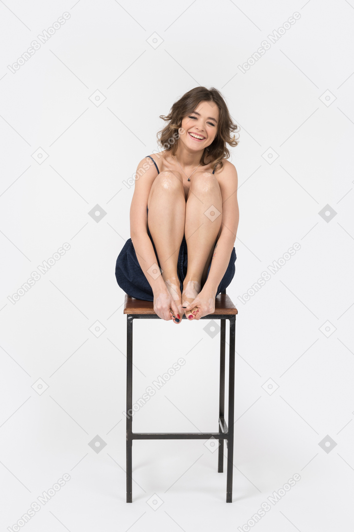 Delighted woman laughing in lotus position