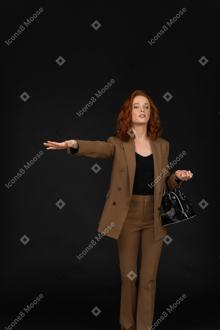 Young businesswoman hailing a taxi
