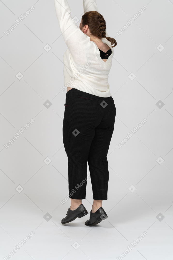 Plump woman in casual clothes jumping