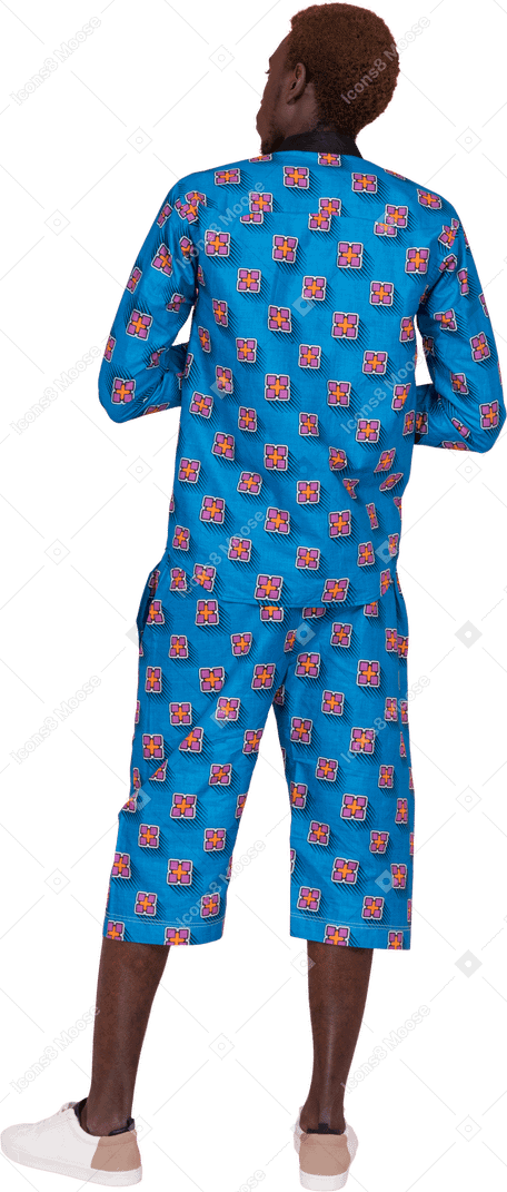 Black man in blue pajamas standing
