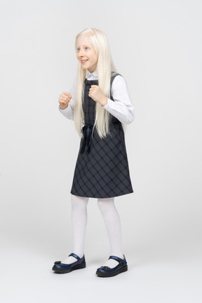 Schoolgirl looking excited with her fists up
