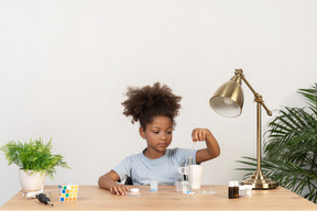 Good looking cute girl doing science at the table