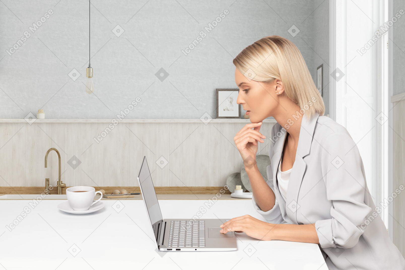 A woman working on a laptop in a kitchen