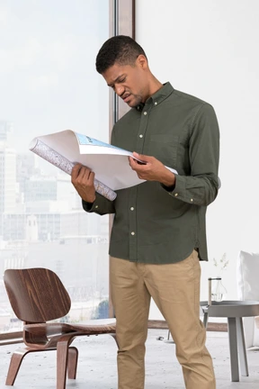 Confused young man trying to read a map