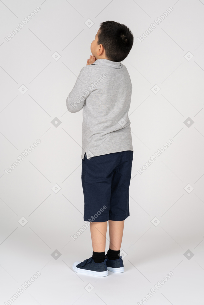 Side view of a boy praying