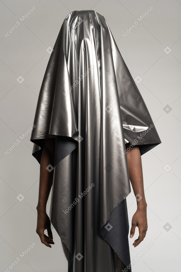 Man standing covered with silver satin