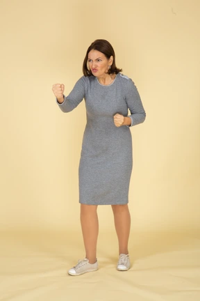 Front view of an angry woman in grey dress