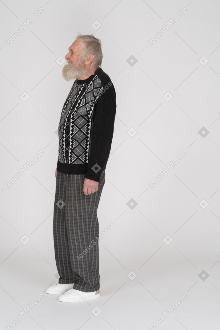 Side view of happy elderly man standing