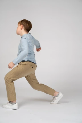 A little boy taking big steps while walking