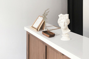 A white bust sitting on top of a white counter